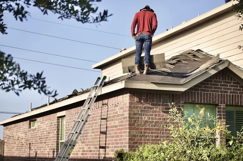 Professional roofer working on a residential roof in Ensley